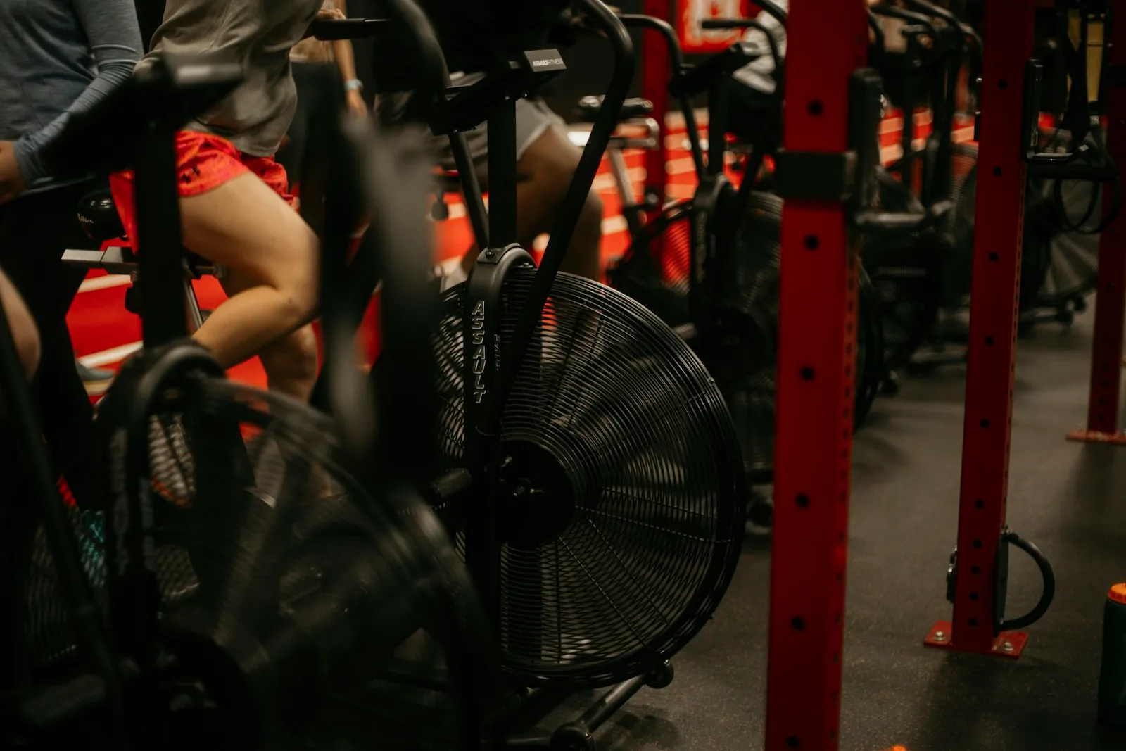People working hard on stationary bikes in an indoor cycling class